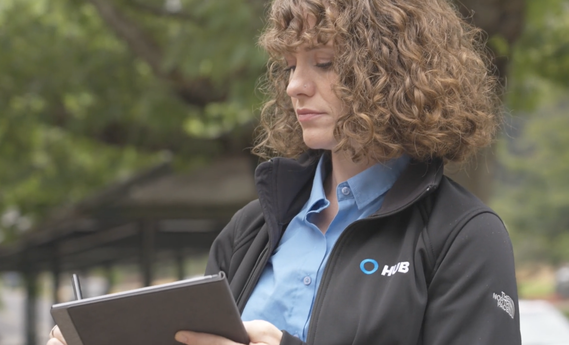 HUB team reviewing a commercial insurance program on a tablet